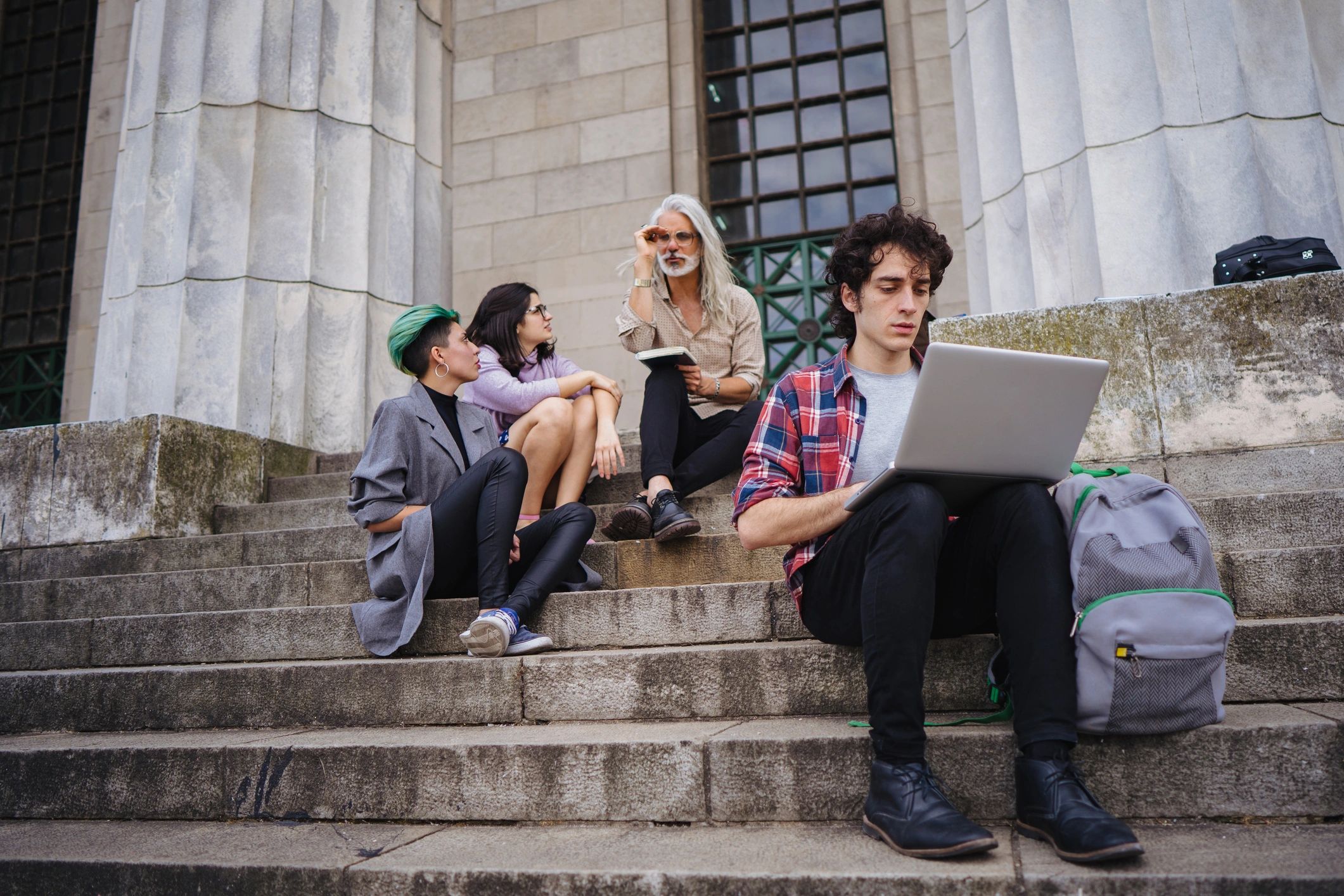 Student researching a team project on a laptop