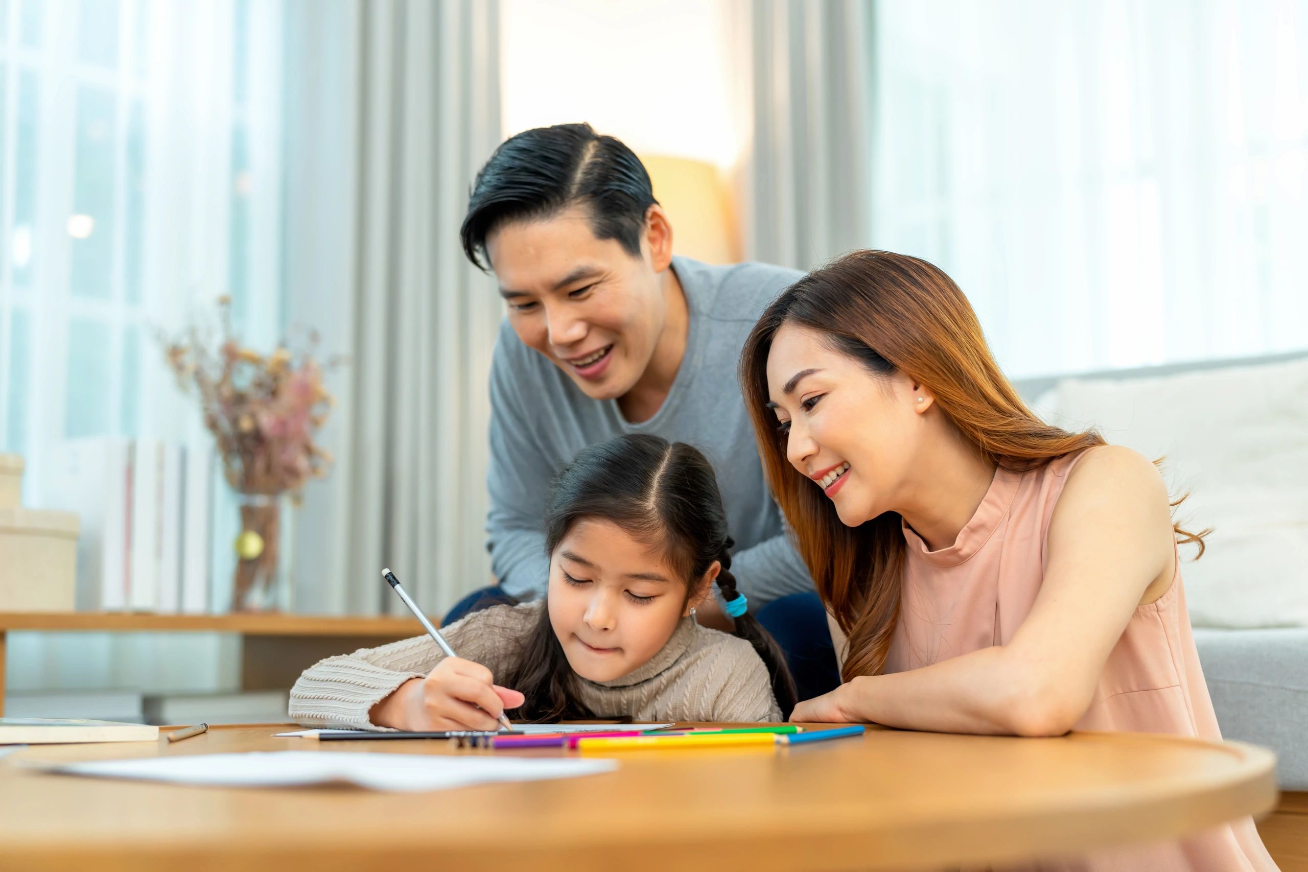 Parents supporting their child during a learning activity at home