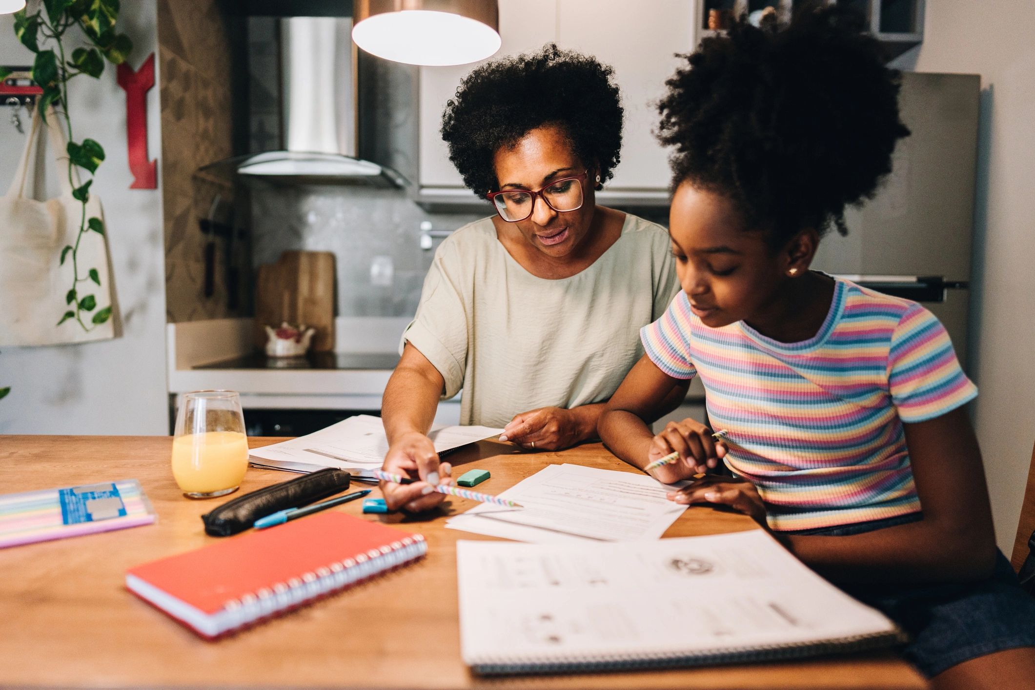 Parent helping a child with homework at home
