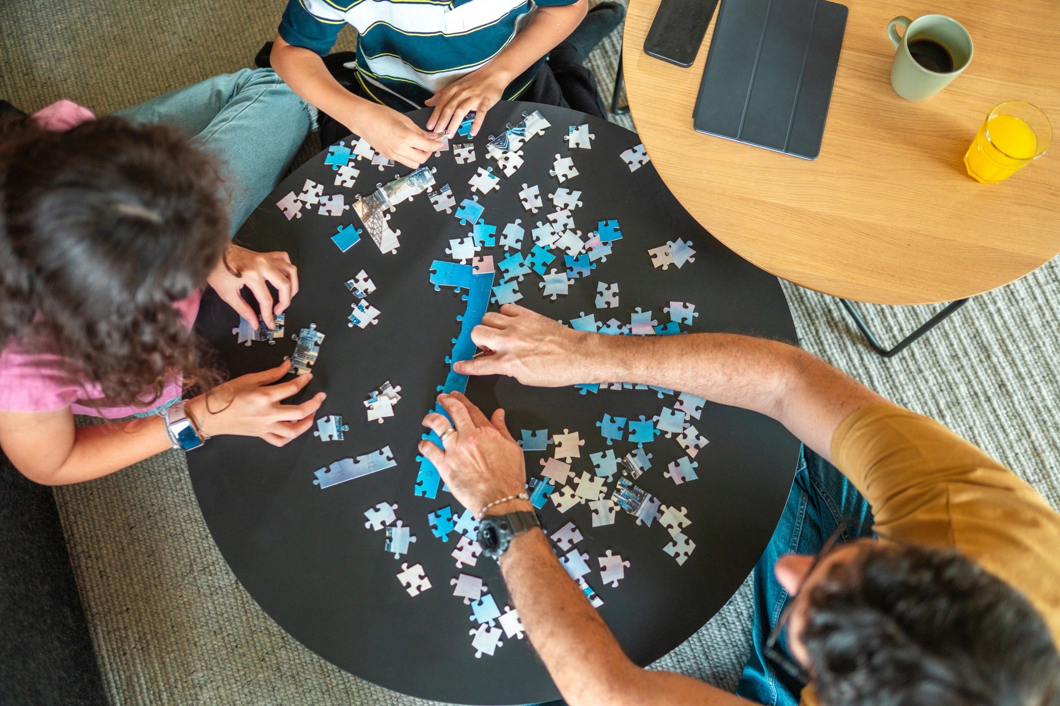 Parent and children enjoying a puzzle challenge